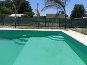 a swimming pool with blue water in front of a fence at Jenaz in Federación +73 photos