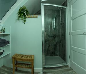 a shower with a glass door in a bathroom at The Walk-up in Portree