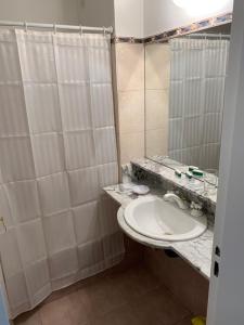 a bathroom with a white sink and a shower at RECOLETA STUDIO in Buenos Aires +10 photos