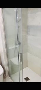 a glass shower in a bathroom with a toilet at Apartamento Sun Beach in Benalmádena