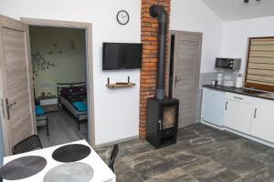 a kitchen with a stove in a room with a table at Natalia Rest domki & camp in Tałty +40 photos