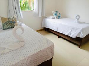 Voodi või voodid majutusasutuse Diamantes House praia de Taperapuan Porto Seguro toas