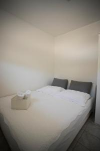 białe łóżko z 2 poduszkami w pokoju w obiekcie Gavran Apartment Vinjerac w mieście Vinjerac