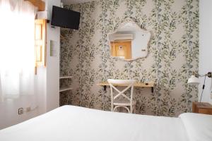 Postel nebo postele na pokoji v ubytování Hostal El Pozo