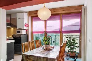a kitchen with a table and chairs and a window at Appartamento IL NIDO tra verde e natura in Berbenno di Valtellina