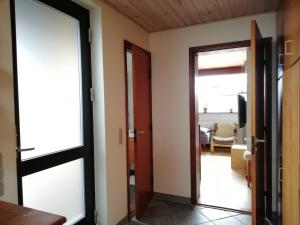 a hallway with a door leading to a living room at Kløvermarken 14 in Herning