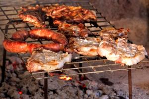 a group of meat and sausages on a grill at Agriturismo Parmoleto in Montenero