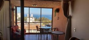 a room with a table and a view of the ocean at 4 Norte 221 Vista al Mar y Casino in Viña del Mar