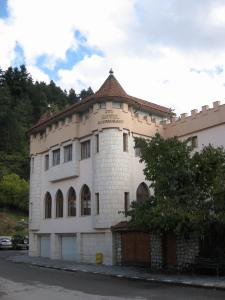 a large white building with a roof at The Castle Hotel in Samokov