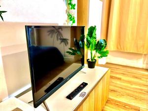 Uma televisão e/ou sistema de entretenimento em *Tropical*Hyper centre *Fibre Wifi*Studio