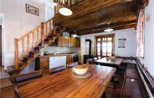a dining room with a wooden table and a staircase at 1 Bedroom Lovely Home In Hrnjanec in Hrnjanec