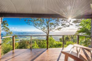 a view from the deck of a house with a bench at The Polish Place in Mount Tamborine