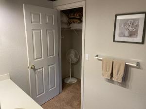 a bathroom with a door leading to a closet with towels at Escape To Branson in Branson