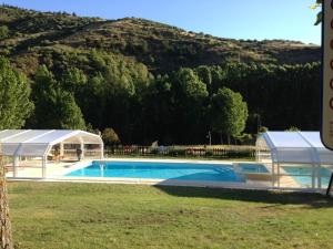a swimming pool with a tent next to a mountain at A. Montesinho Turismo in Bragança