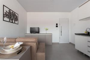 a living room with a couch and a table at Galileia flat in Santa Maria