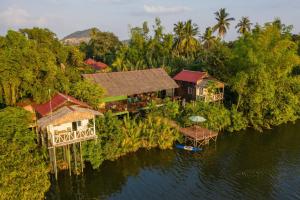 an aerial view of a house on an island in the water at Green Mango Bungalows in Kampot