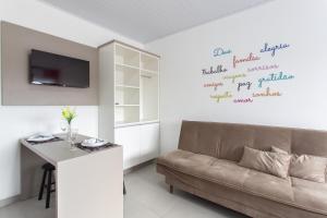 a living room with a couch and a table at Galileia flat in Santa Maria