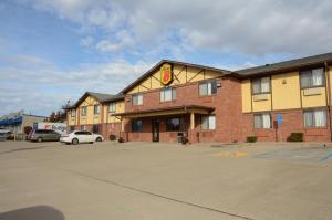 a hotel with a car parked in a parking lot at Super 8 by Wyndham Warrenton in Warrenton