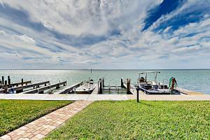 a dock with two boats on the water at La Solana Condominiums #111 in South Padre Island