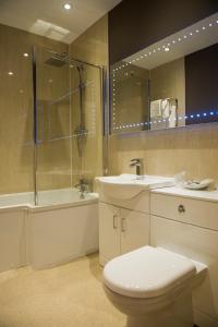 a bathroom with a toilet and a sink and a shower at Somerton House Hotel in Lockerbie
