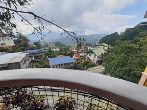 a view of a city from a balcony at ASHBURN'S TRANSIENT BAGUIO - BASIC SLEEP and GO, LIMITED PAY PARKING, SELF SERVICE in Baguio
