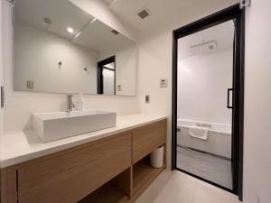 a bathroom with a sink and a mirror at yoin hotel kyoto gion in Kyoto +44 photos