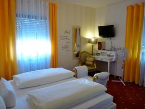 Postel nebo postele na pokoji v ubytování Hotel Geissler