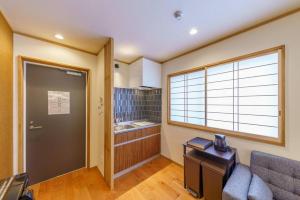 a living room with a couch and a window at YADOYA 梟 in Tokyo