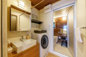 a bathroom with a washing machine and a sink at YADOYA Fukurou in Tokyo +27 photos
