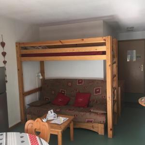 a living room with a bunk bed and a couch at Appart st François longchamp in Saint-François-Longchamp