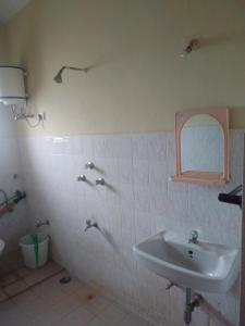 a bathroom with a sink and a mirror at The Gipsy Cove, Baga Beach in Baga