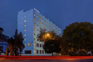 a white building with a sign on it at night at KHAS Surabaya in Surabaya