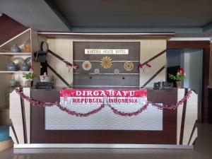 a display in a room with a sign that reads dragonplay u revolutionary imperialism at RedDoorz near Poso City Mall in Poso