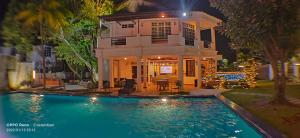 a house with a swimming pool in front of a house at Seremban Grande Villa 163 by Vale Pine in Seremban