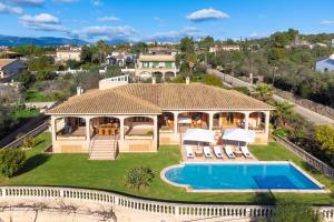 an aerial view of a house with a swimming pool at Vista Mar y Tierra in Marratxí 