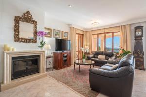 a living room with a couch and a fireplace at Vista Mar y Tierra in Marratxí 