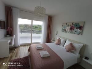 a bedroom with a large bed and a large window at FAMILY VILLA WITH POOL-Peaceful Hvar Island Oasis in Bogomolje +33 photos