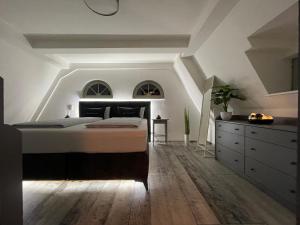 a bedroom with a large bed and a dresser at Alter Kornspeicher in Havelberg
