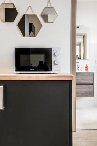 a microwave sitting on a counter in a kitchen at Centre - Le Contemporain - Parking in Drulingen