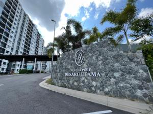 a sign for a hotel in a city with a building at Desaru Utama Residance Aisy Homestay in Kota Tinggi