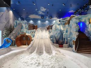 an indoor amusement park with a slide in the snow at i-Suite, i-City by Mohas Homes in Shah Alam