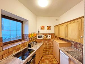 a kitchen with a sink and a window at Fewo Ziemer in Piding