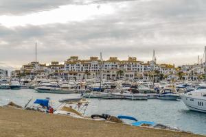 a marina filled with lots of boats next to a body of water at Pensión Aduar in Marbella