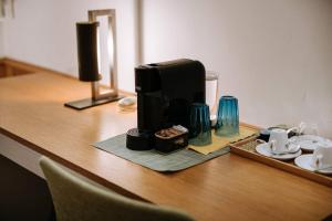 a coffee maker sitting on top of a wooden table at Santa Rosa Relais in Noci
