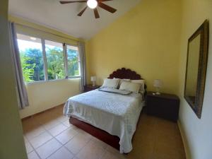 a bedroom with a bed and a large window at Las Brisas, Juan Dolio, 3br, 3 Pools, Jacuzzi, Beach, Golf, Polo in San Pedro de Macorís +66 photos
