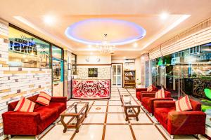 a lobby with red couches and tables in a store at RIJ Hulhumale in Hulhumale