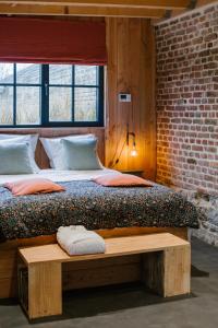 Cama ou camas em um quarto em La cabane du potager - Ferme de Linciaux