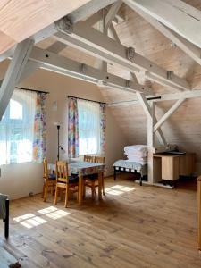 a room with a table and chairs in a attic at Czarna Jachta - Na szlaku legend - - - - - Pokoje nad jeziorem in Kruklanki