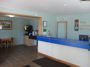 a waiting room with a blue counter and a table at Tiki Lodge in Medford