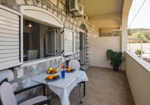 a table with fruit on it on a balcony at Adriatic Dream Apartments in Dubrovnik